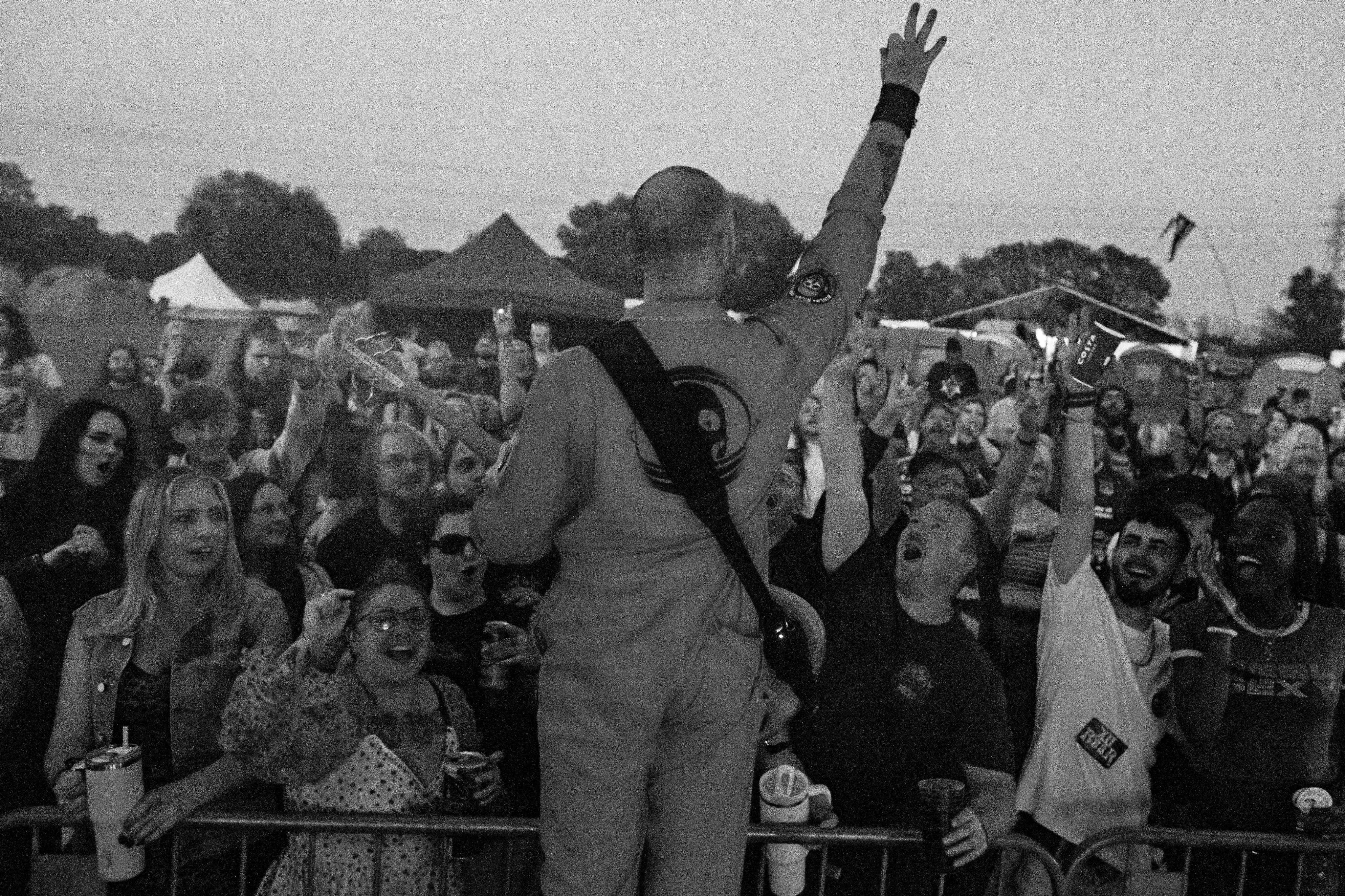 Black and white photo of teens rehearsing a dance routine on a stage.