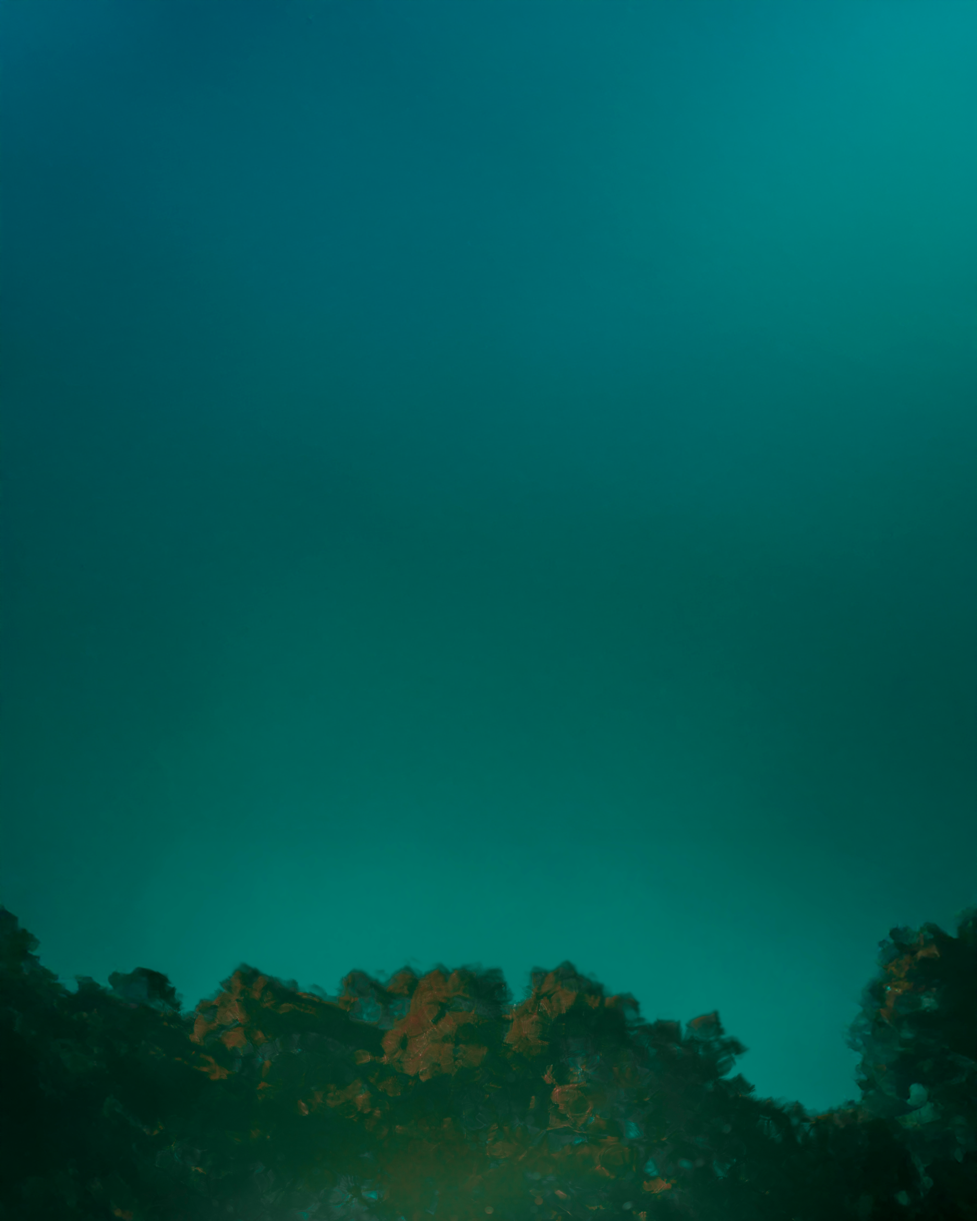 Black and white photo of a women performing modern dance on a dark background.